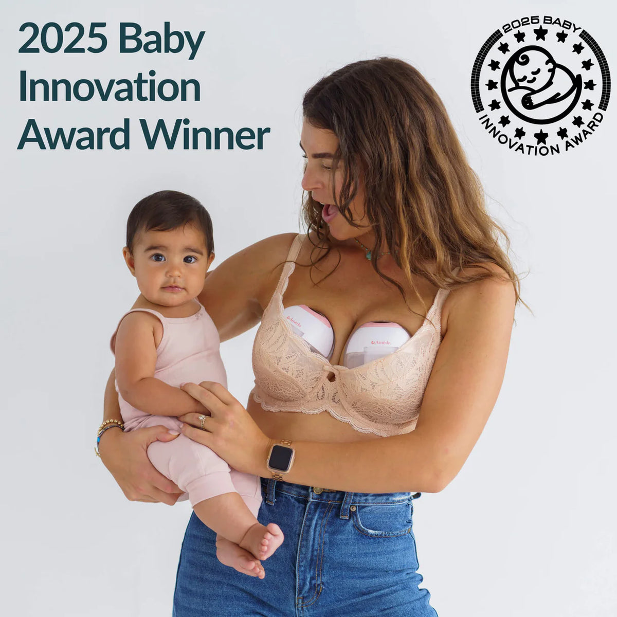 A mother holding her baby while wearing Ameda GLO pumps inside her bra, with a 2025 Baby Innovation Award badge